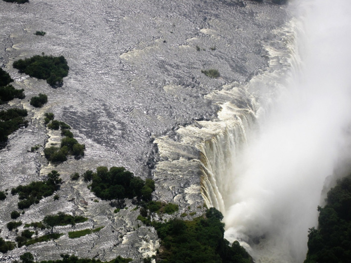 Mist rising over Victoria Falls at sunrise, Zimbabwe–Zambia border